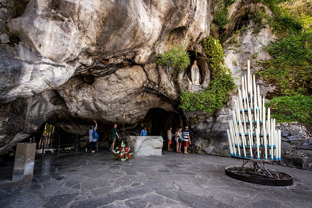 tourists visiting Lourdes grotto